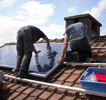  picture of worker installing solar panel